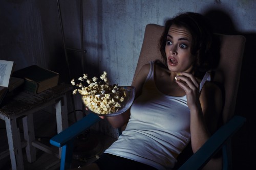 woman, scared horror movie, popcorn drops